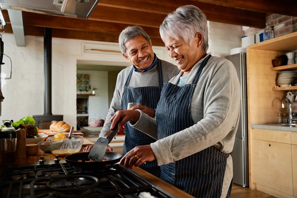 A couple cooking together in their kitchen